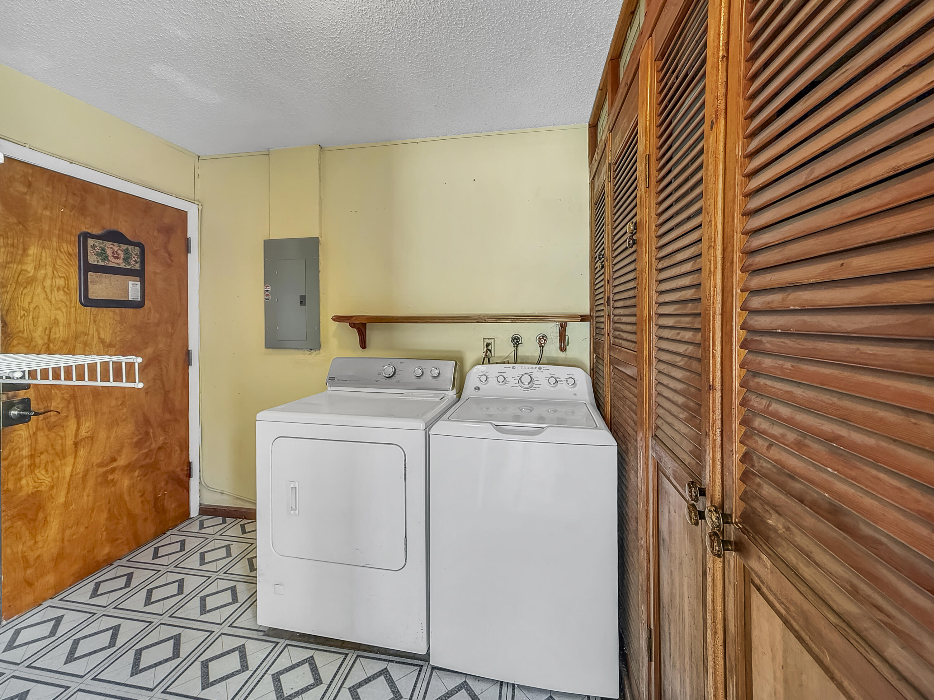 4387 Appian Way Greenacres, FL 33463 - Photo 12 of 14 a utility room with dryer and washer