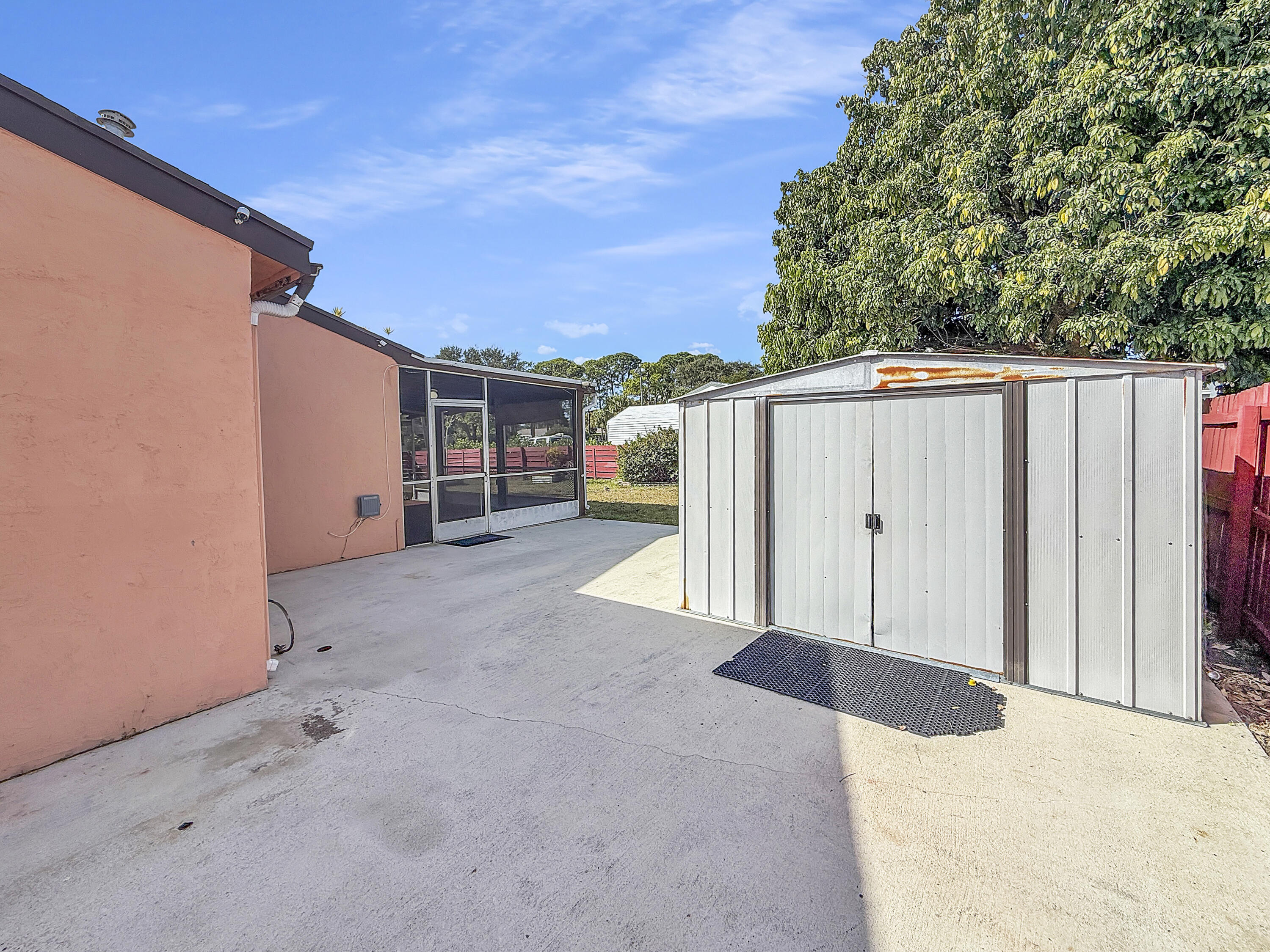 4387 Appian Way Greenacres, FL 33463 - Photo 14 of 14 a view of backyard with tub and trees in the background