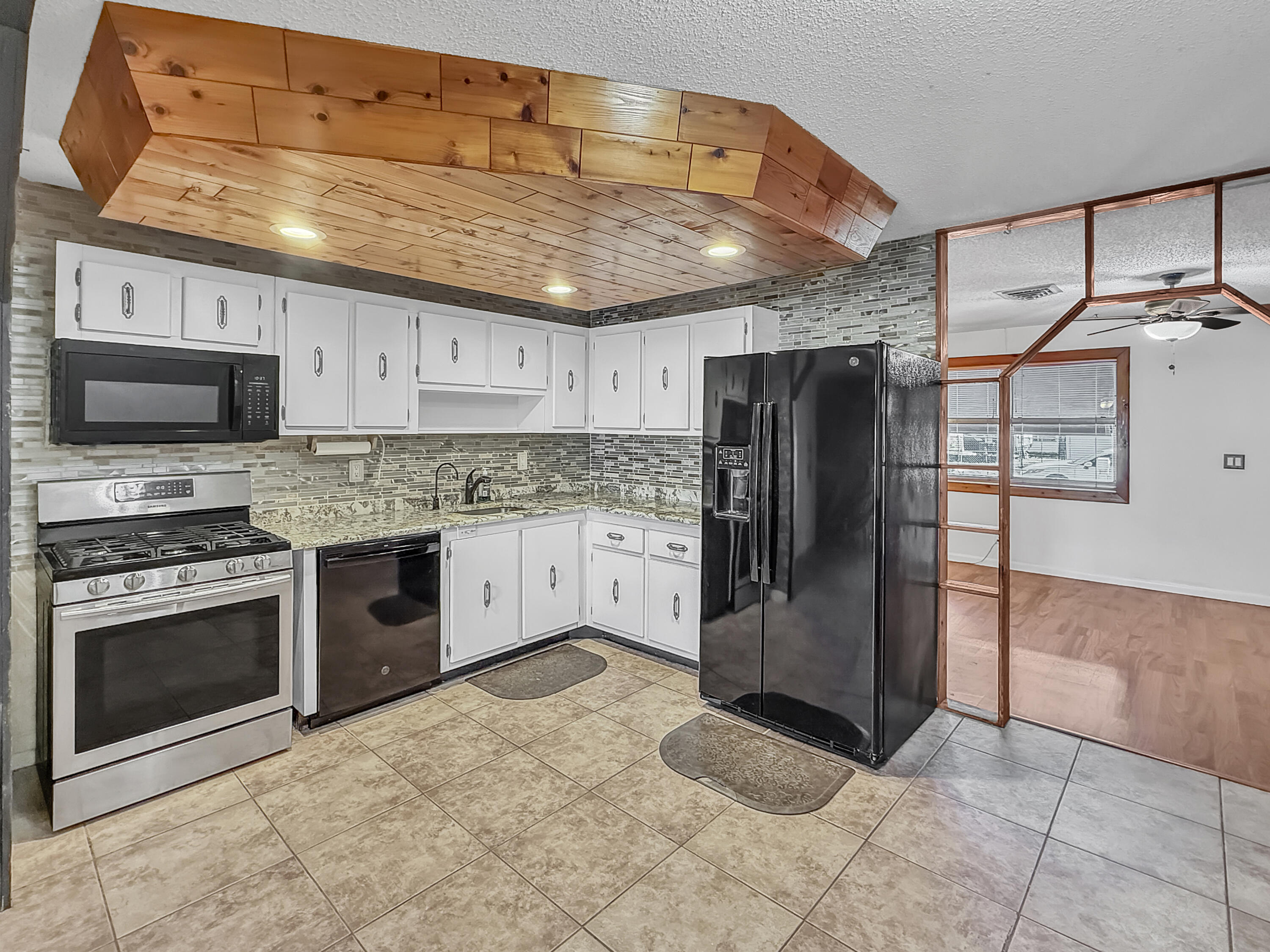 4387 Appian Way Greenacres, FL 33463 - Photo 5 of 14 a kitchen with stainless steel appliances granite countertop a refrigerator oven a sink and dishwasher