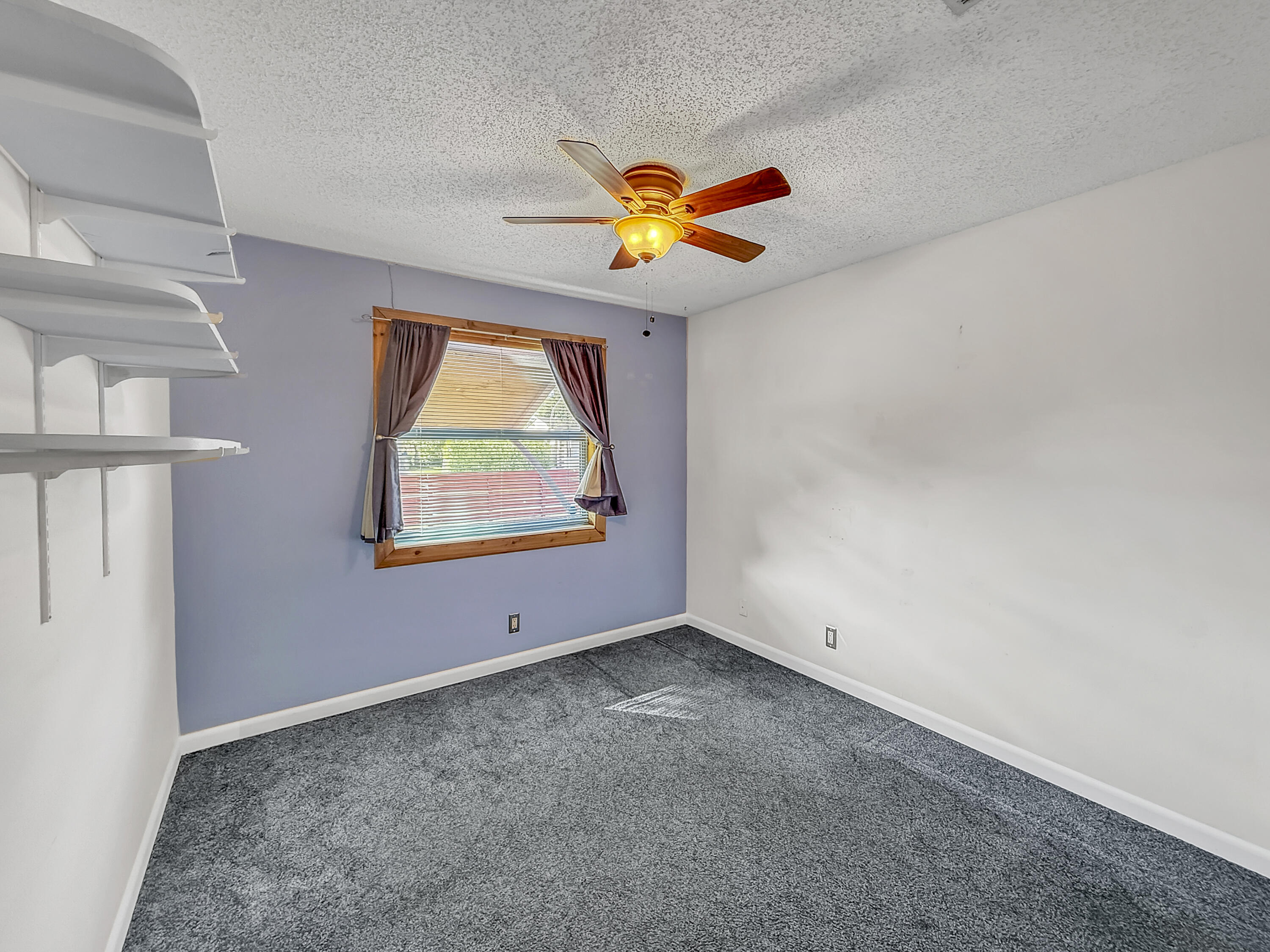 4387 Appian Way Greenacres, FL 33463 - Photo 7 of 14 an empty room with windows and fan