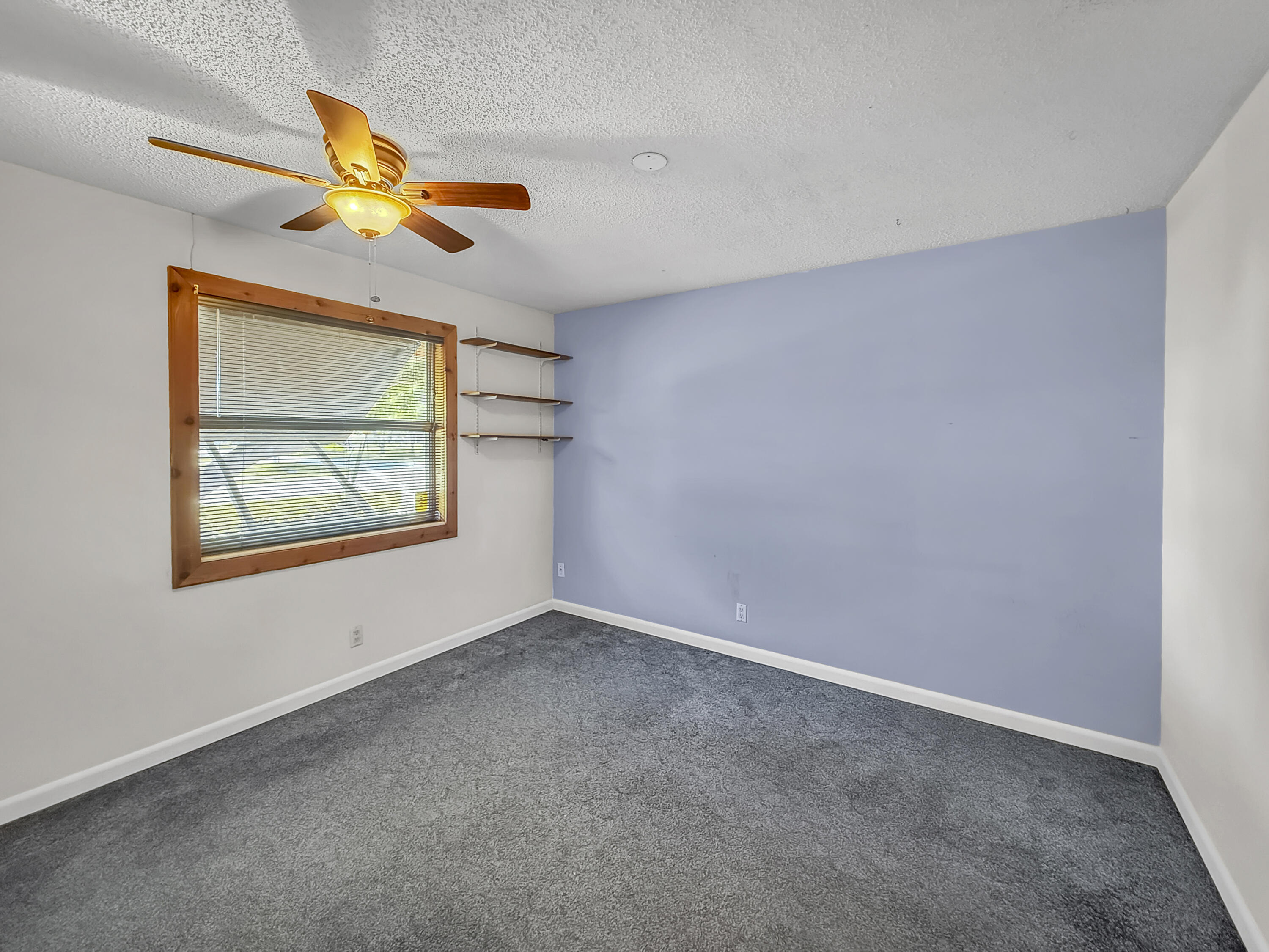 4387 Appian Way Greenacres, FL 33463 - Photo 9 of 14 an empty room with windows and fan