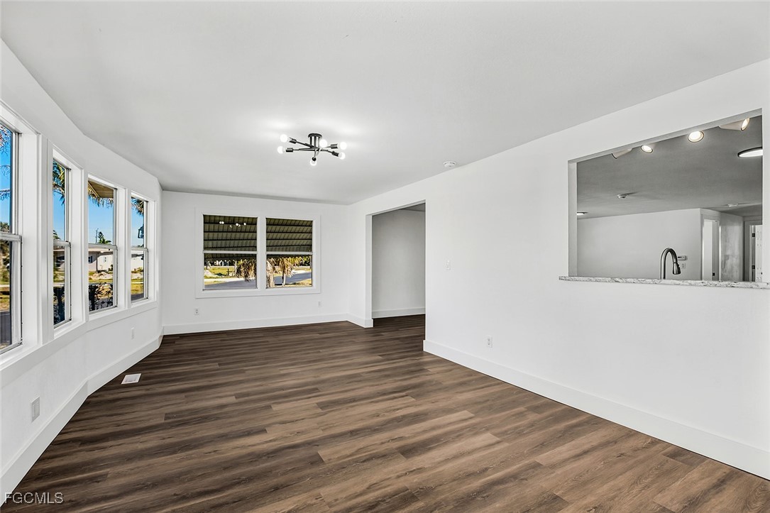 13651 Grackle Road Fort Myers, FL 33908 - Photo 7 of 43 a view of an empty room with wooden floor and a window