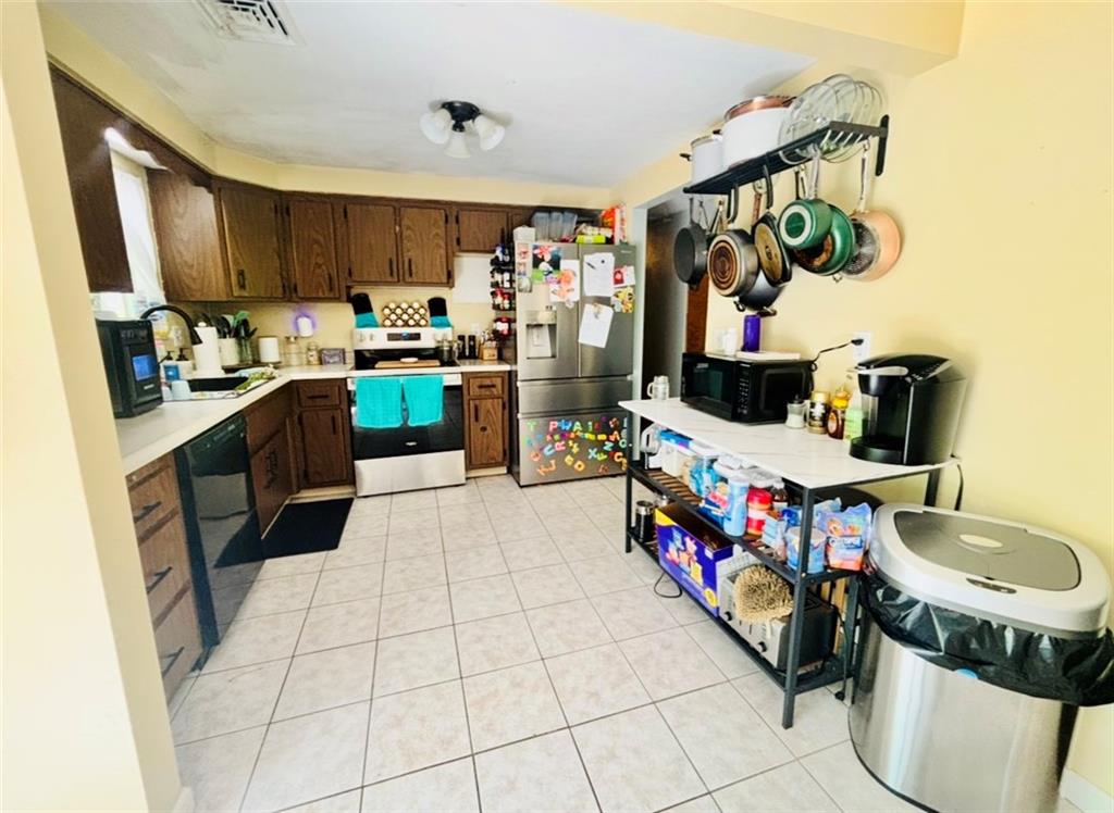 87 McMichael Road Carnegie, PA 15106 - Photo 4 of 20 a kitchen with stainless steel appliances granite countertop a sink a stove and a refrigerator