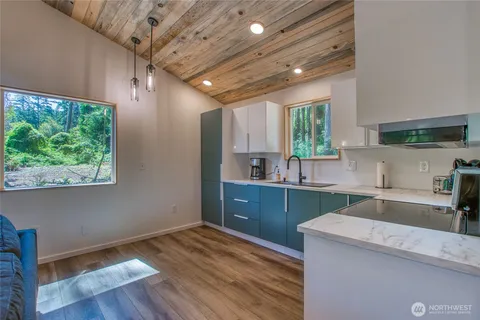 a kitchen with sink cabinets and wooden floor