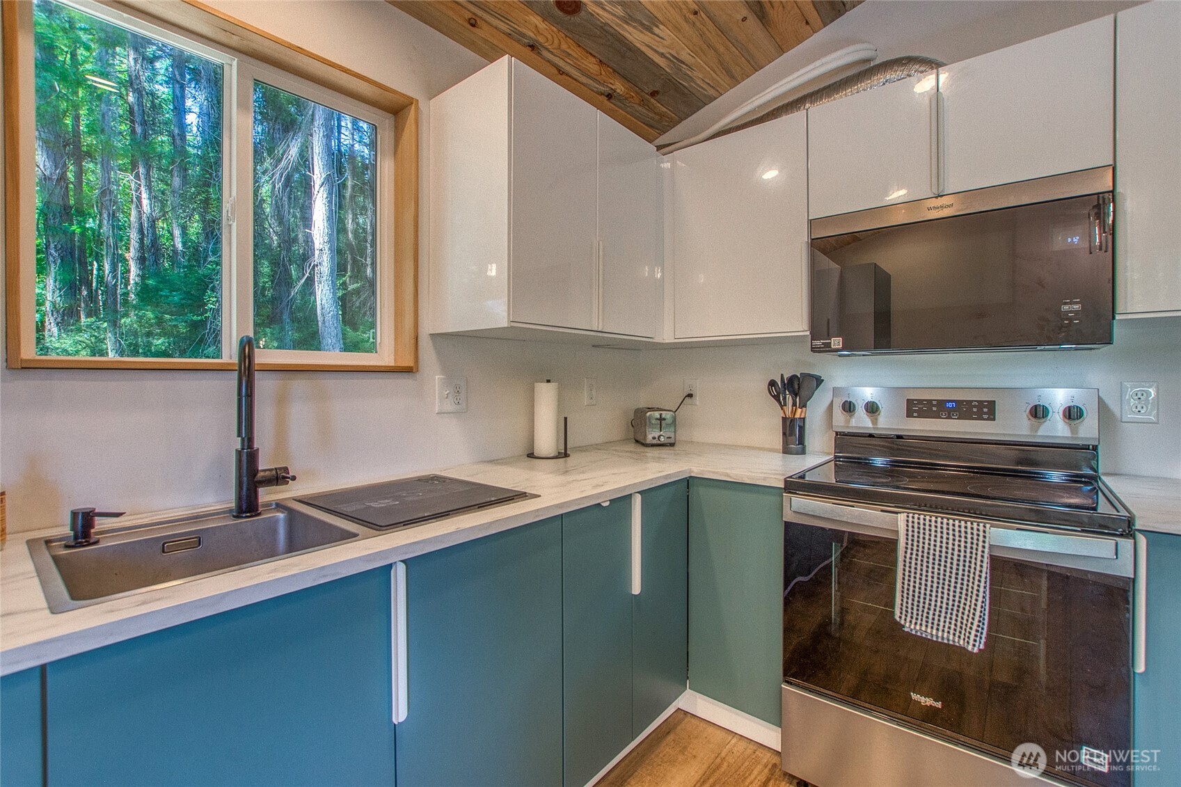 311 Enchanted Forest Road Orcas Island, WA 98245 - Photo 17 of 26 a kitchen with a sink stove and microwave
