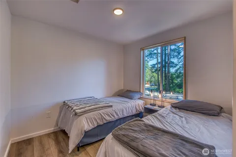 a bedroom with two beds and a window