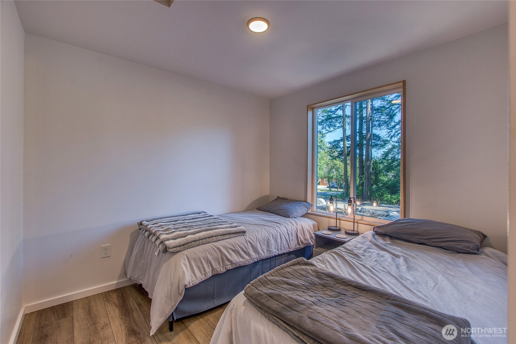 311 Enchanted Forest Road Orcas Island, WA 98245 - Photo 20 of 26 a bedroom with two beds and a window