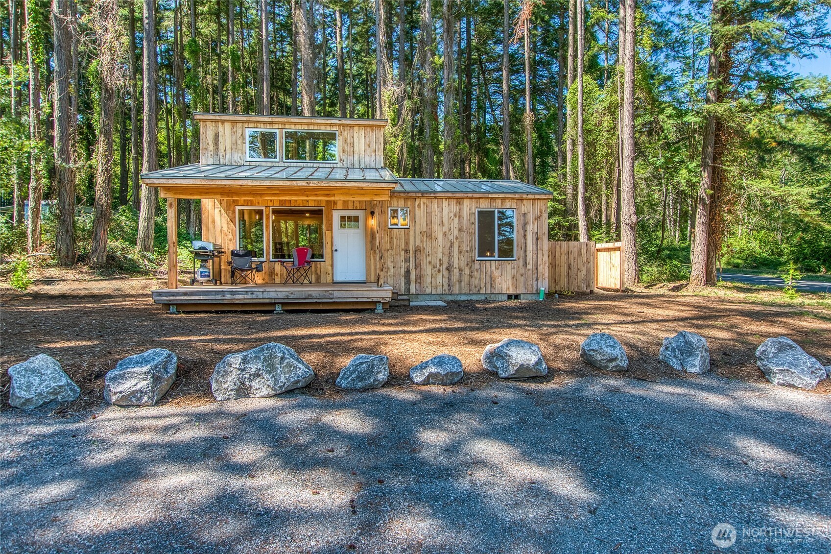 311 Enchanted Forest Road Orcas Island, WA 98245 - Photo 2 of 26 a view of a white house with a swimming pool and wooden fence