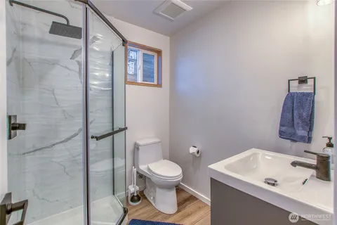 a bathroom with a toilet a sink and a shower