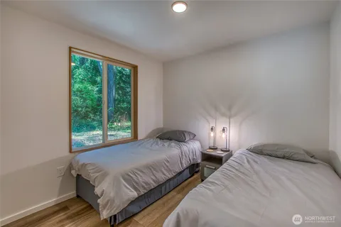 a bedroom with two beds and a window