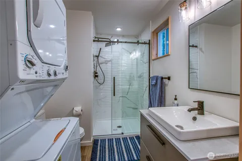 a bathroom with a sink a toilet and shower