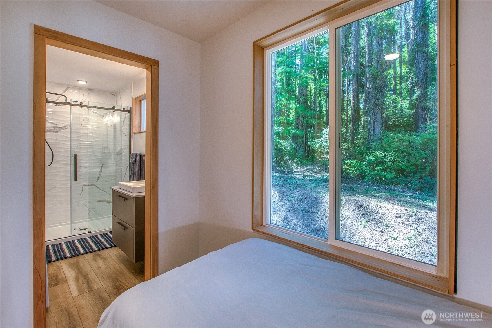 311 Enchanted Forest Road Orcas Island, WA 98245 - Photo 24 of 26 a bedroom with a bed and a large window