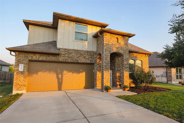a front view of a house with garden
