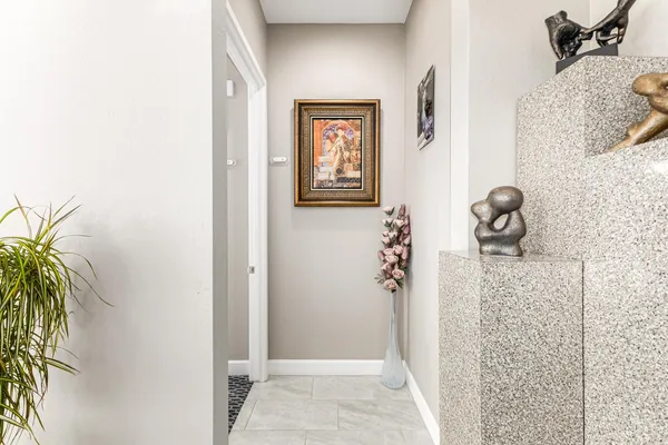 a view of a hallway with paintings on the wall
