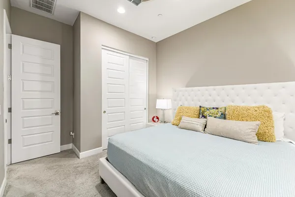 a bedroom with a bed and cabinet