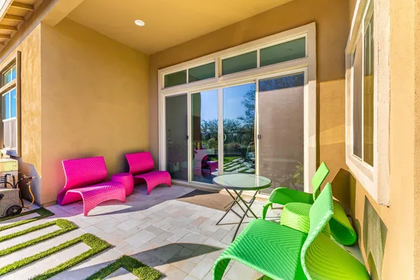 a living room with a bed and glass windows