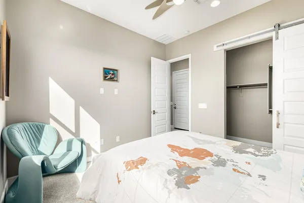 a bedroom with a bed and mirror