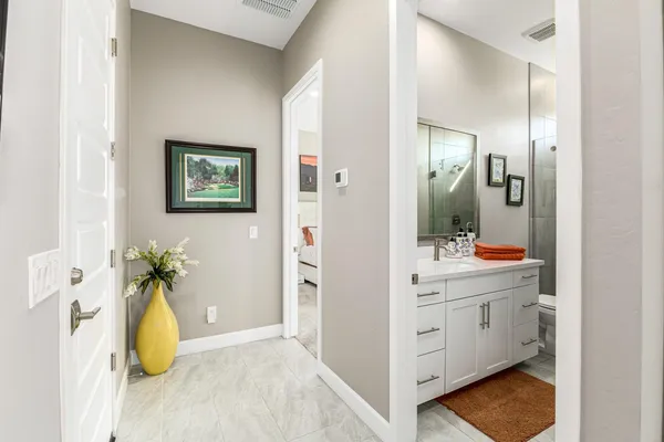a bathroom with a sink a mirror and a shower