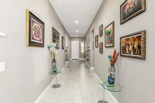 a view of a hallway with paintings on the wall