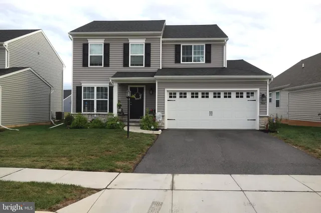 a view of a white house with a yard