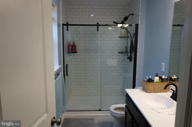 a bedroom with a bed and mirror