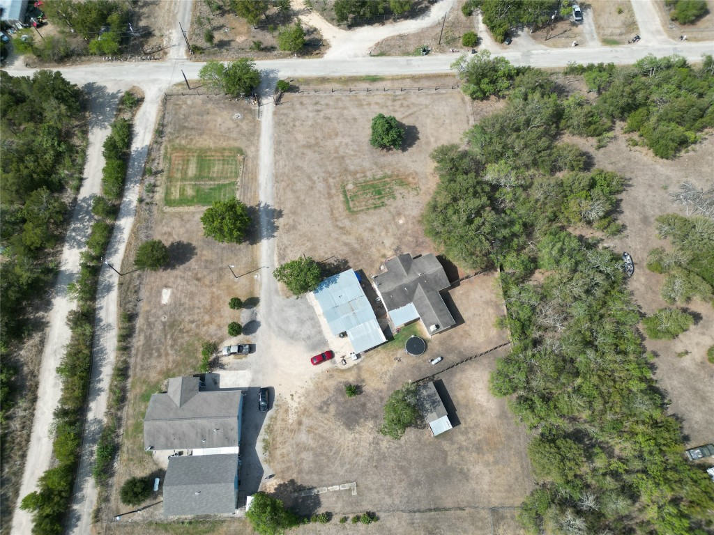 an aerial view of a house with yard and patio