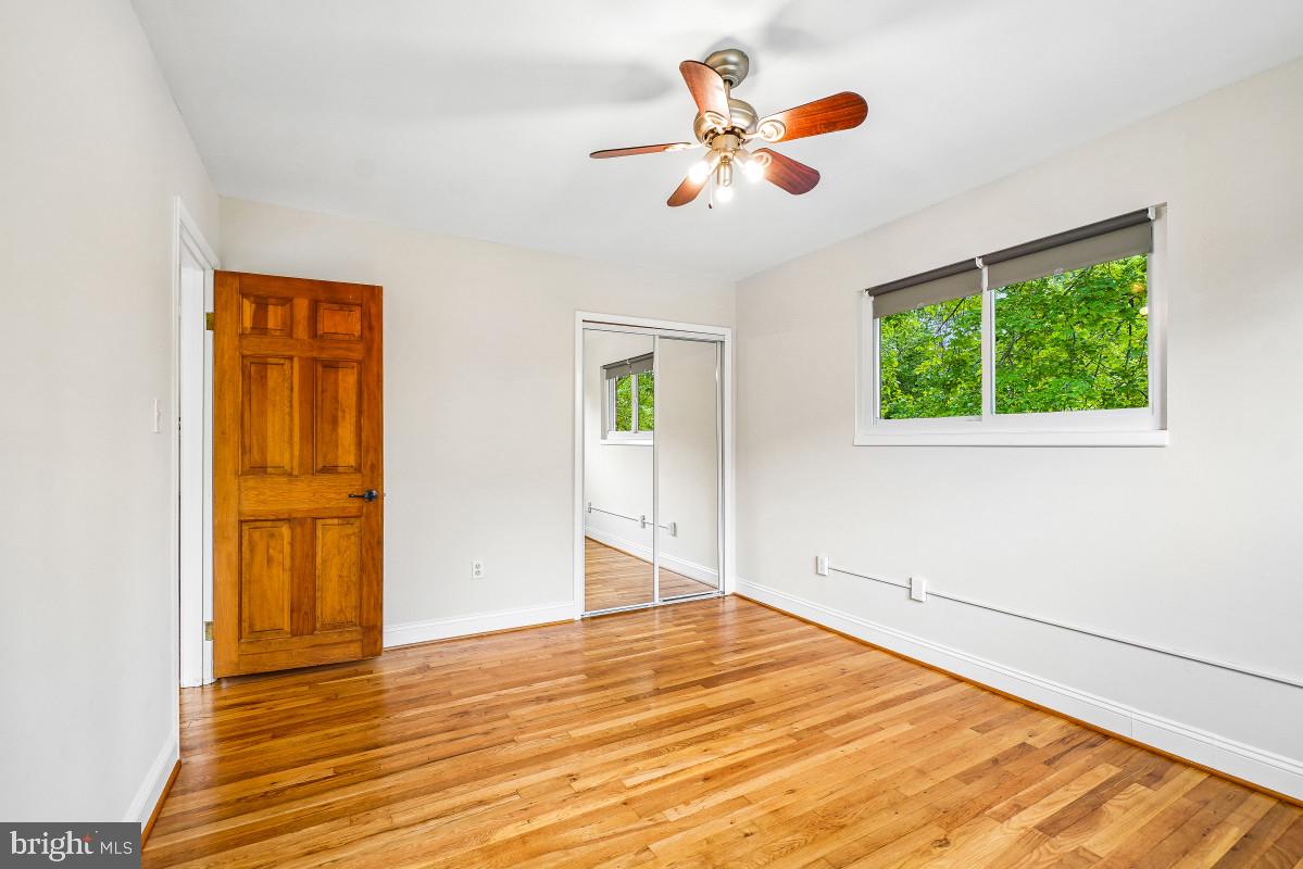 827 Caddington Avenue Silver Spring, MD 20901 - Photo 24 of 45 a view of a room with wooden floor and ceiling fan