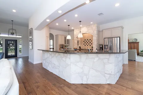 a view of a kitchen with a sink and a large window