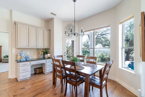 a view of a dining room with furniture window and wooden floor