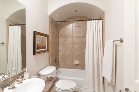 a bathroom with a toilet a sink and bathtub