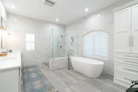 a spacious bathroom with a large tub and shower