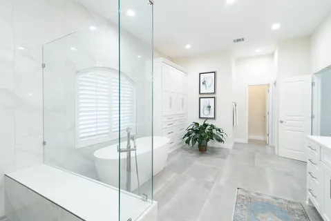 a bathroom with a tub shower and sink