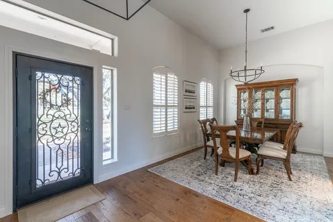 a dining room with furniture and window