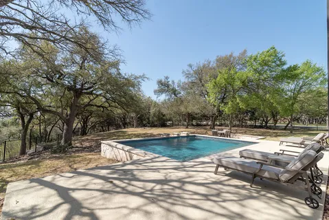a view of a swimming pool with lounge chair