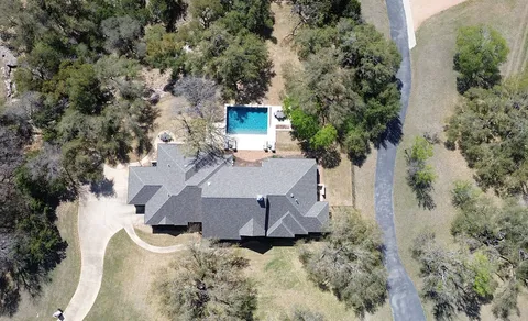 an aerial view of a house with yard