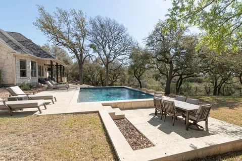 a view of a swimming pool with lounge chairs