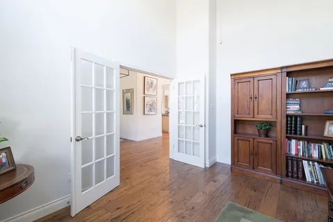 an entryway with workspace and wooden floor