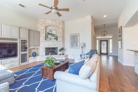 a living room with furniture fireplace and wooden floor