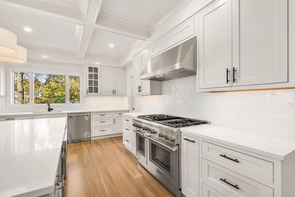 21 Beechnut Road Westwood, MA 02090 - Photo 11 of 41 a kitchen with stainless steel appliances a stove a white cabinets and a wooden floor