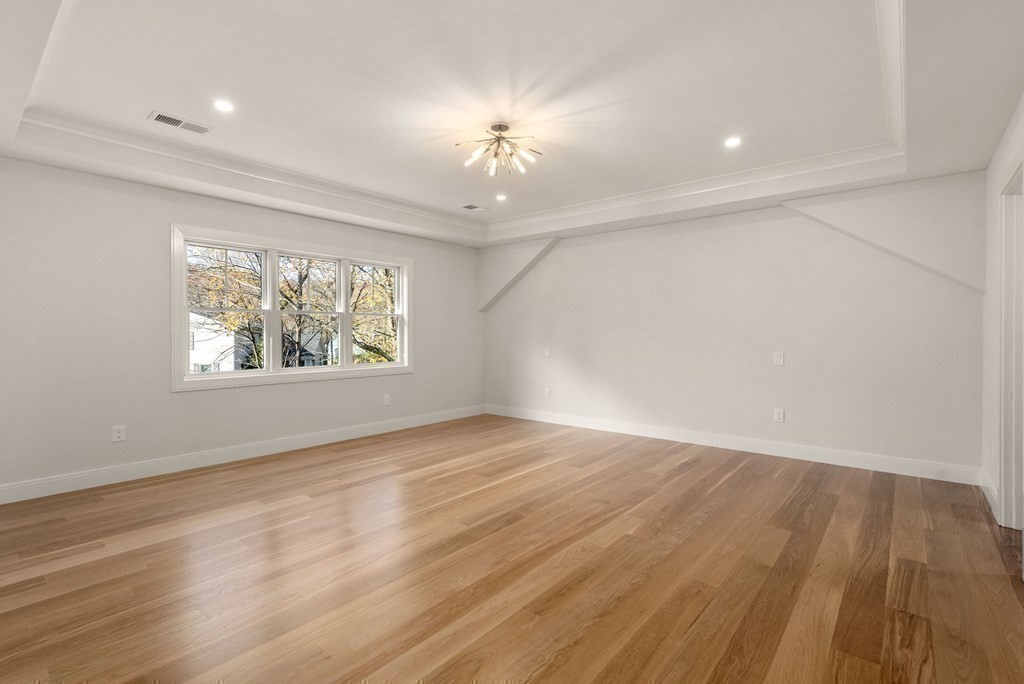 21 Beechnut Road Westwood, MA 02090 - Photo 21 of 41 an empty room with wooden floor chandelier and windows