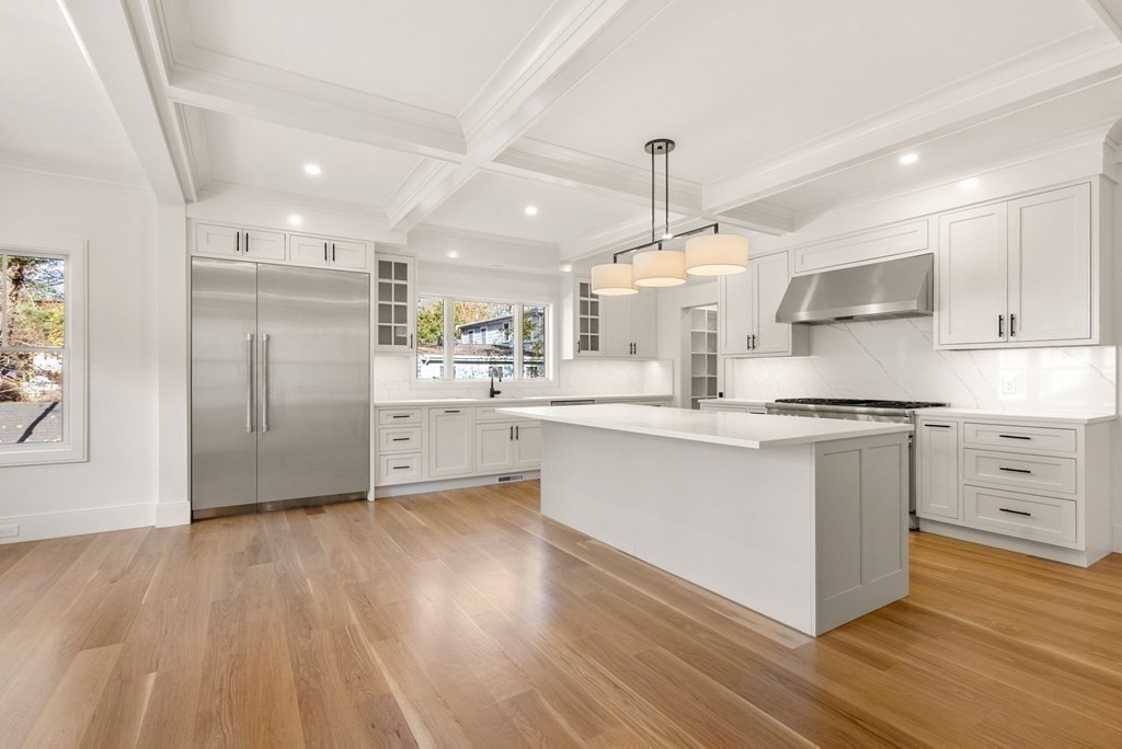 21 Beechnut Road Westwood, MA 02090 - Photo 8 of 41 a kitchen with stainless steel appliances kitchen island hardwood floor sink and stove