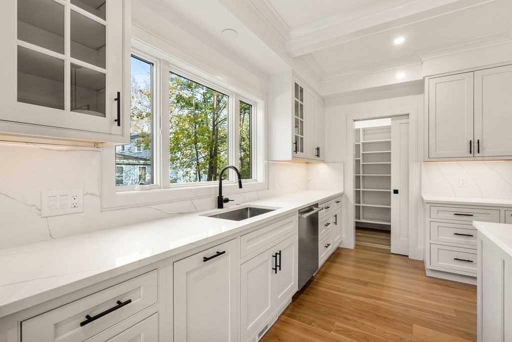 21 Beechnut Road Westwood, MA 02090 - Photo 10 of 41 a kitchen with kitchen island granite countertop white cabinets and window