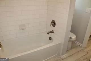 a bathroom with a bathtub and a toilet