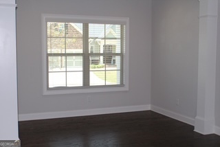 1958 Lola Lane Southwest Marietta, GA 30064 - Photo 5 of 42 an empty room with wooden floor and windows