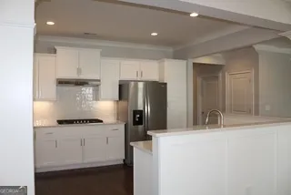 a kitchen with a refrigerator and a sink