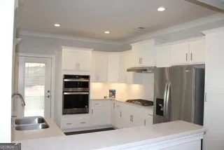 a kitchen with a refrigerator and a stove