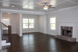 1958 Lola Lane Southwest Marietta, GA 30064 - Photo 10 of 42 an empty room with wooden floor fireplace and windows