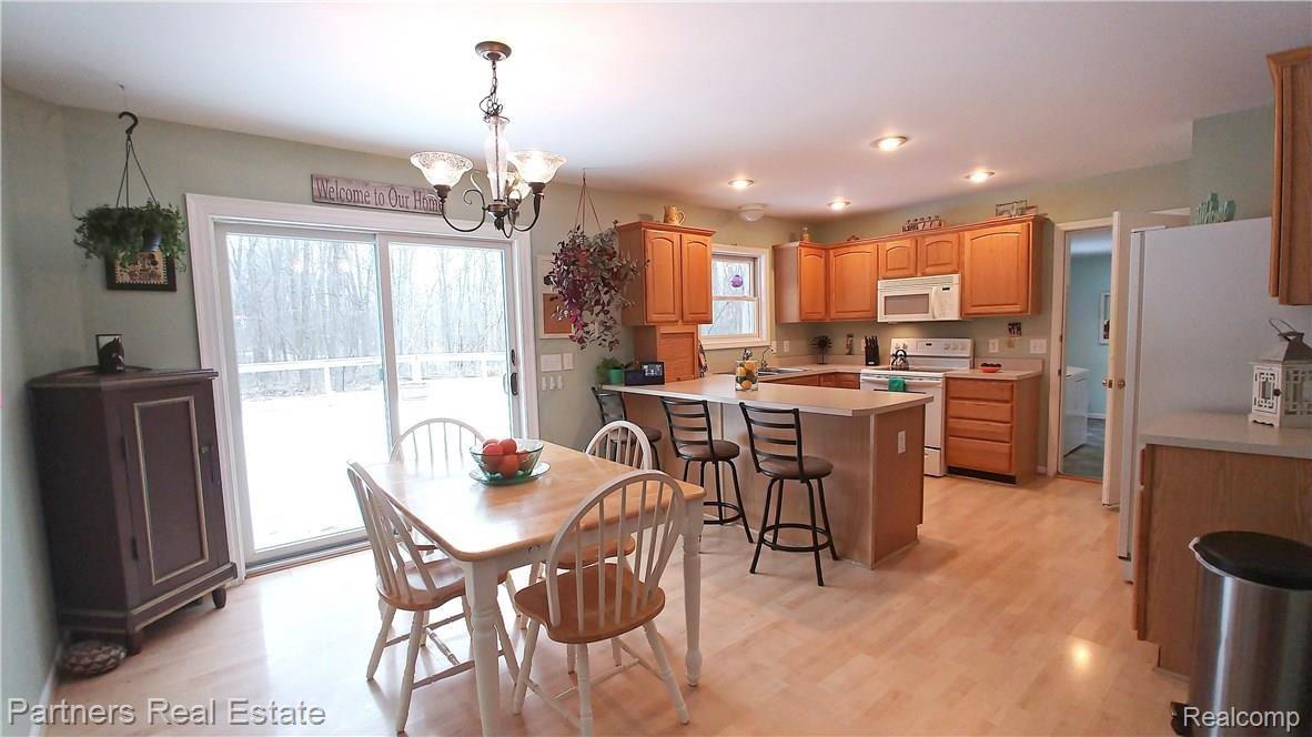 5371 Dutton Road Gregory, MI 48137 - Photo 11 of 72 Kitchen/Dining combo, with slider to deck. Snackbar and efficient kitchen with canned ceiling lights.