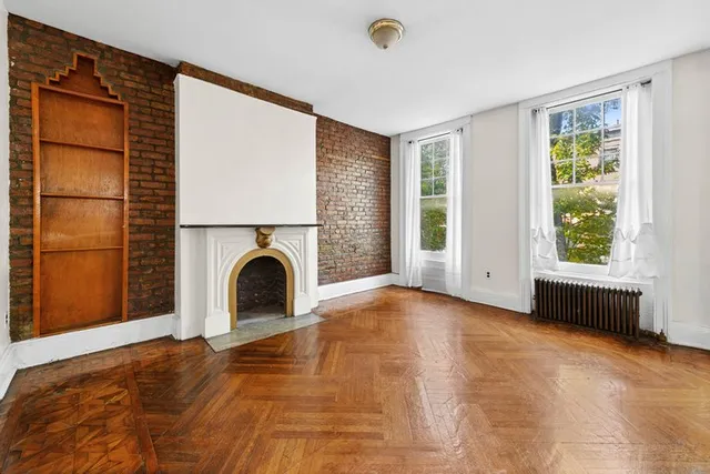 a view of empty room with window and fireplace