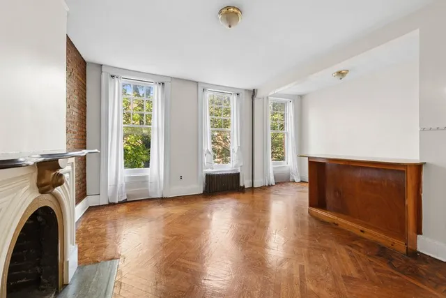 a view of a livingroom with furniture and a window